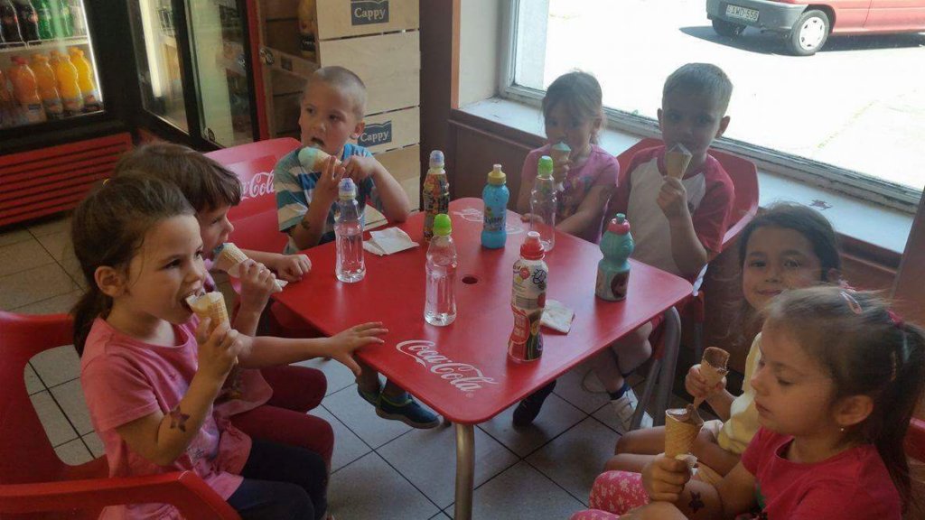 Gyerekek jégkrémet esznek asztalnál